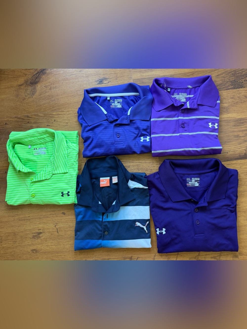 4 Under Armour Men's golf shirts and 1 Puma men’s golf shirt. XXL dry fit.